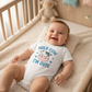 Baby wearing Holy Cow onesie