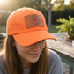 Orange hat with patch being worn