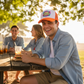 Orange trucker hat with DTF design being worn