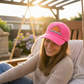 Pink hat with DTF design being worn