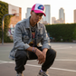 Pink trucker hat with DTF design being worn