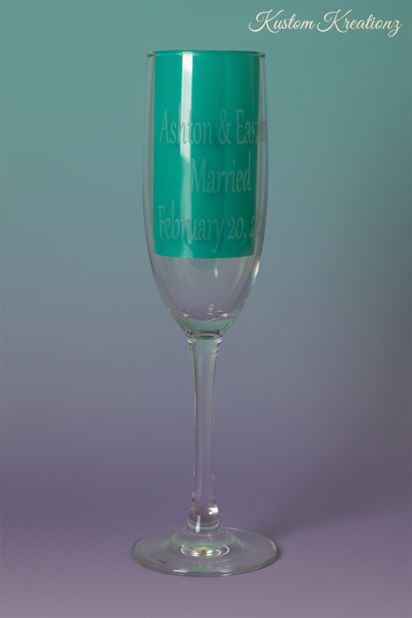 Stemmed champagne flute with teal backing and Kustom Kreationz branding
