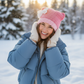 Woman wearing pink cat ear beanie outdoors